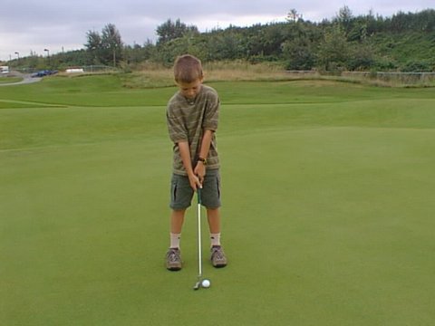 Zachary putting at the 2nd green