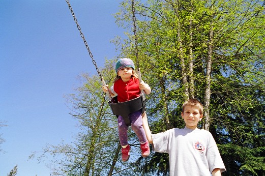 Zachary pushing Jessica on swing